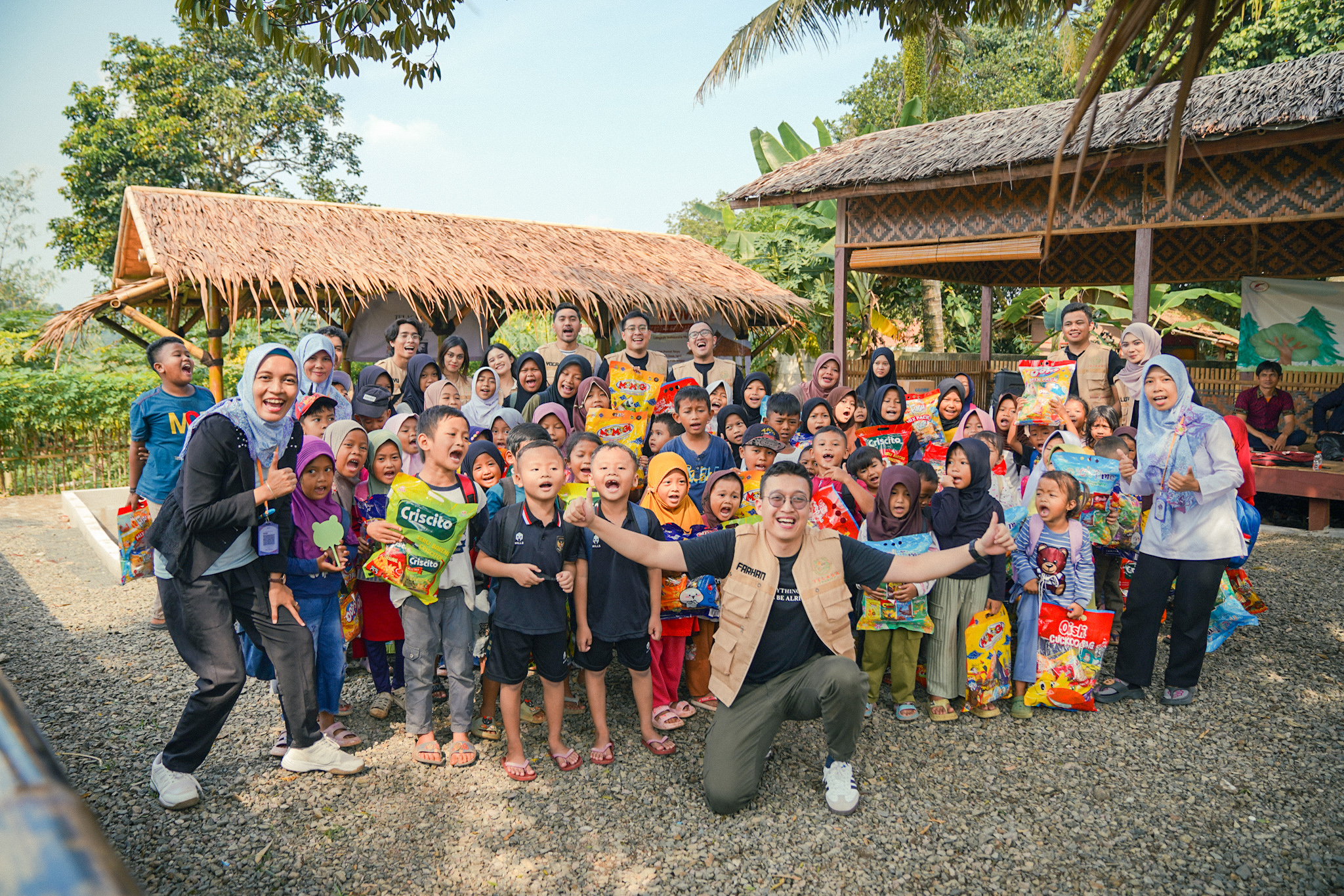 Children receiving snacks from Telaga Charity